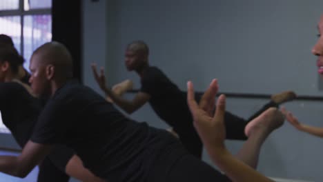 multi-ethnic group of fit male and female modern dancers practicing a dance routine