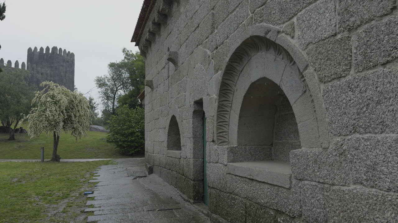 Ancient Stone Building and Castle under a Rainy Sky