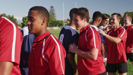 rugby players meeting opposing team on the field