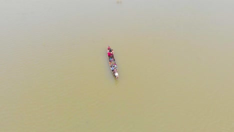 4k aerial top down shot of people in a row boat getting evacuated to land area in majuli river island submerged in the brahmaputra monsoon floods