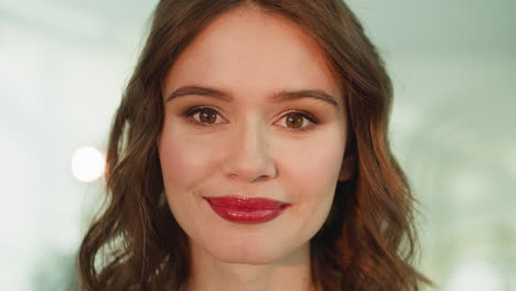 portrait of attractive curly-haired woman looking in camera