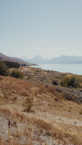 scenic drive along lake with mountains in new zealand