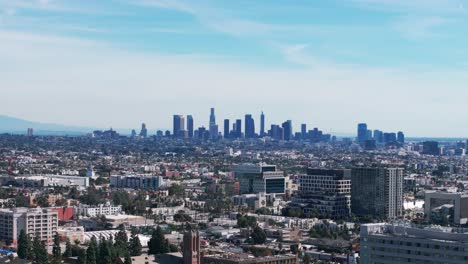 static drone aerial shot of the los angeles skyline with some smog