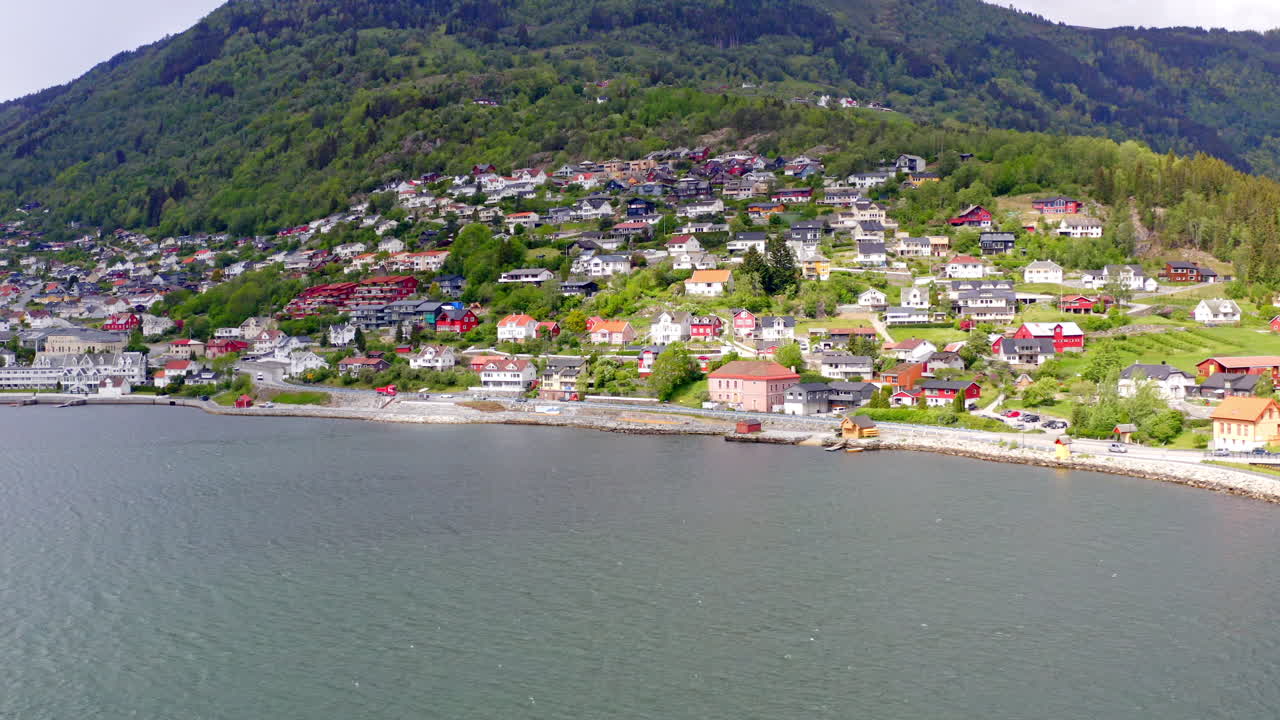 Majestic aerial view of Sogndal, Norway with the Sognefjord, lush mountains, and Sogndal Bridge under clear skies. Breathtaking Nordic landscape in soft natural light