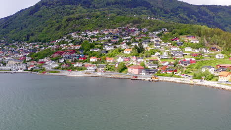 majestic aerial view of sogndal, norway with the sognefjord, lush mountains, and sogndal bridge under clear skies. breathtaking nordic landscape in soft natural light