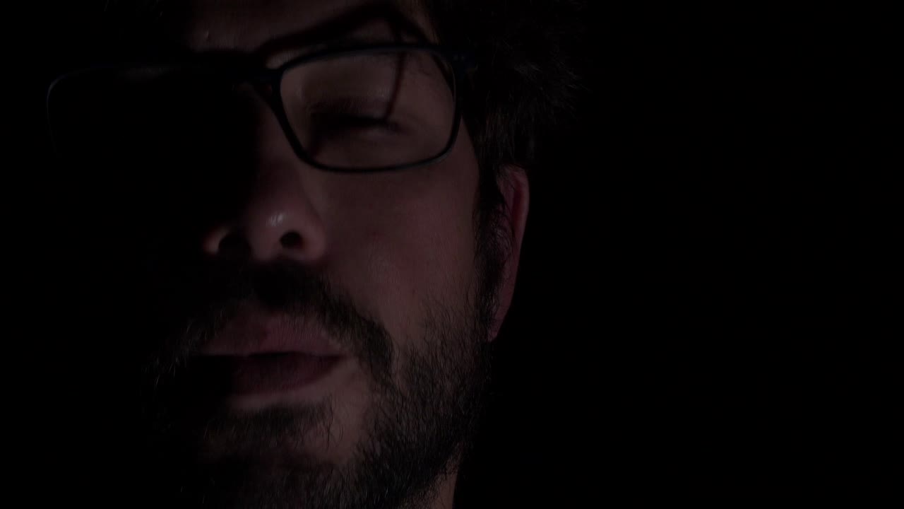Portrait Young Guy with Glasses and Beard, Smoking, Copy Space, Black Background, Close Up