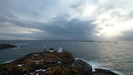 Aerial-view-flyover-of-lighthouse-out-to-sea,-Lofoten,-Norway---Drone-4k