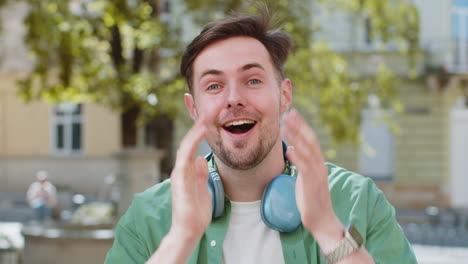 Amazed-man-looking-surprised-at-camera-with-big-open-eyes,-shocked-by-sudden-victory-good-news