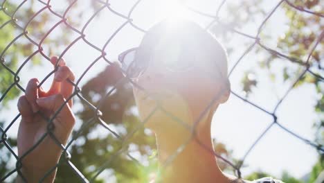 Mixed-race-woman-looking-through-a-fence-