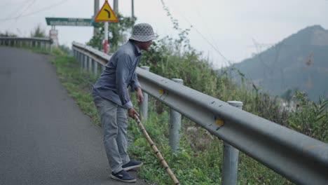 man working on a mountain road