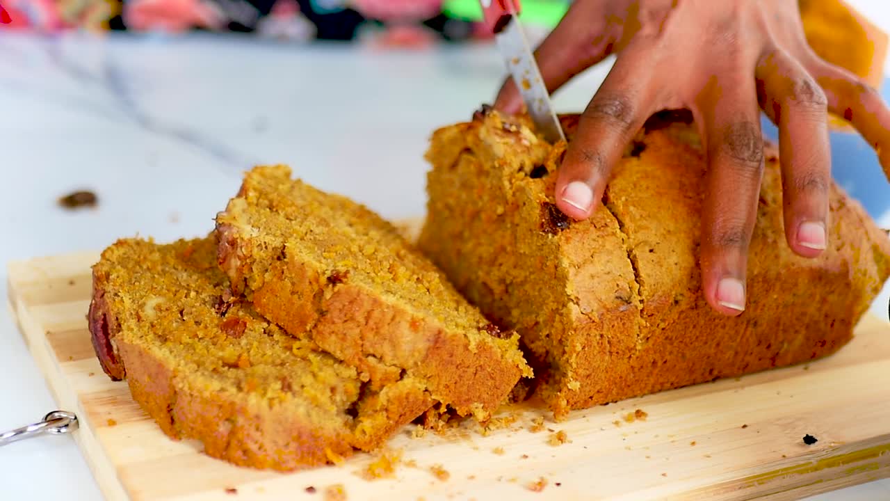 Elegance in every slice! Watch a woman skillfully cutting a delicious cake for a sweet celebration
