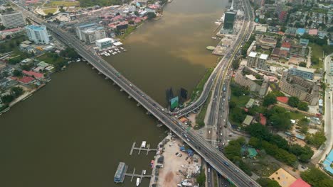 Traffic-and-cityscape-of-Victoria-Island,-Lagos,-Nigeria-featuring-Falomo-Bridge,-Lagos-Law-school-and-the-Civic-centre-tower