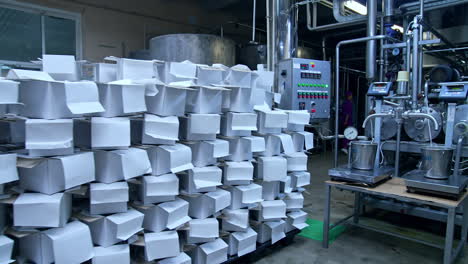 milk plant premises with modern technological equipment. a pile of carton boxes prepared for the dairy products packaging.
