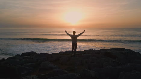 man silhouette standing sunset hill back view. unknown person looking horizon