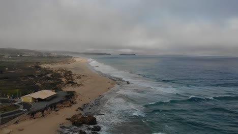 Ponta-da-Calheta-beach-at-Porto-Santo-island-on-stormy-day,-Madeira-in-Portugal