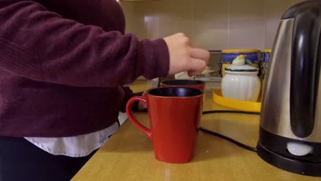 woman making a hot drink in the kitchen