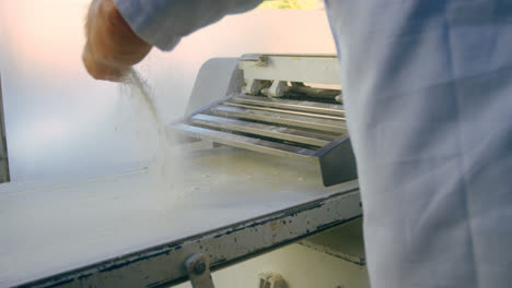 male chef using dough sheeter machine 4k