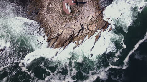 top-down aerial of rocky outcrop in atlantic, with doringbaai lighthouse