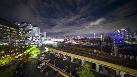 trains arriving and departing from london waterloo station at night in time-lapse from a vantage point in wide angle