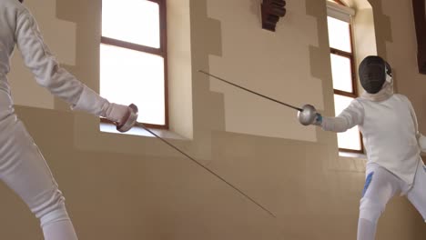 fencer athletes during a fencing training in a gym