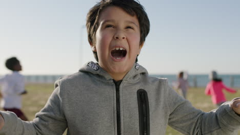 portrait-of-happy-hispanic-boy-playing-making-faces-funny-silly-enjoying-sunny-day-at-seaside-park