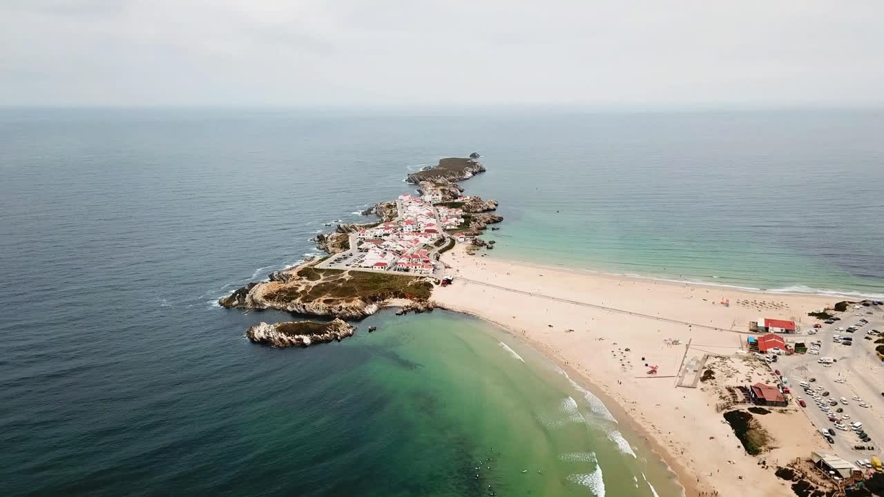 Stunning aerial perspective of Baleal, Portugal, featuring its unique coastal peninsula, sandy beaches, clear waters, and a charming seaside village with vibrant red rooftops