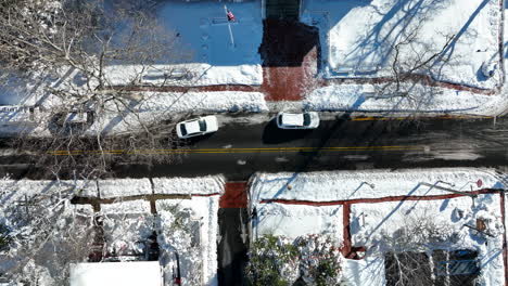 White-car-enters-parking-space-on-street