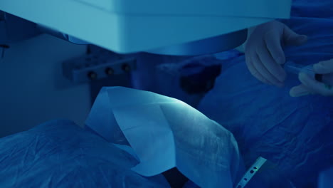 eye surgery on patient. surgeon performing eye procedure on patient in hospital