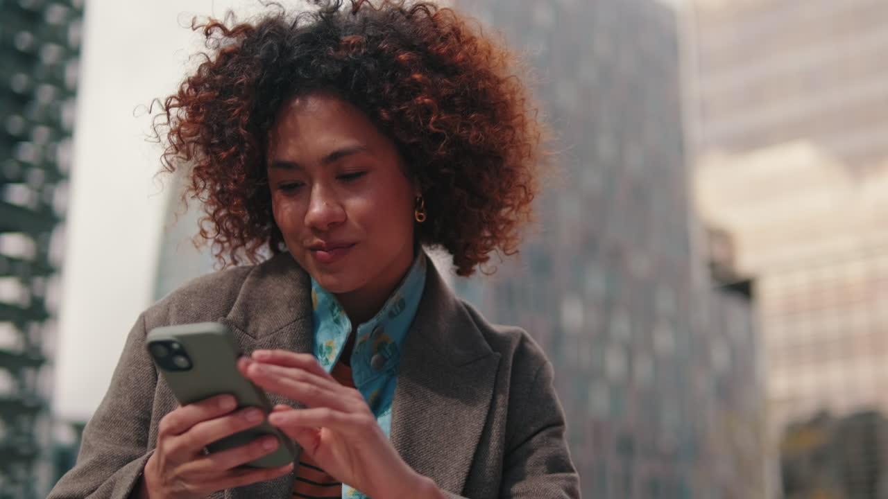 Young Businesswoman Using Smartphone in the City