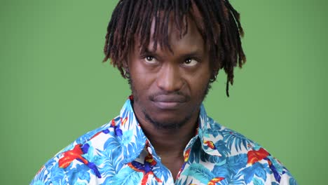 young handsome african tourist man looking bored