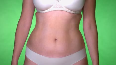 a woman wearing a bra matching with her underwear having a slim tummy without abs