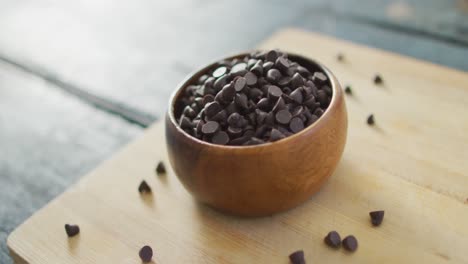 video of close up of bowl with organic chocolate chip on wooden background