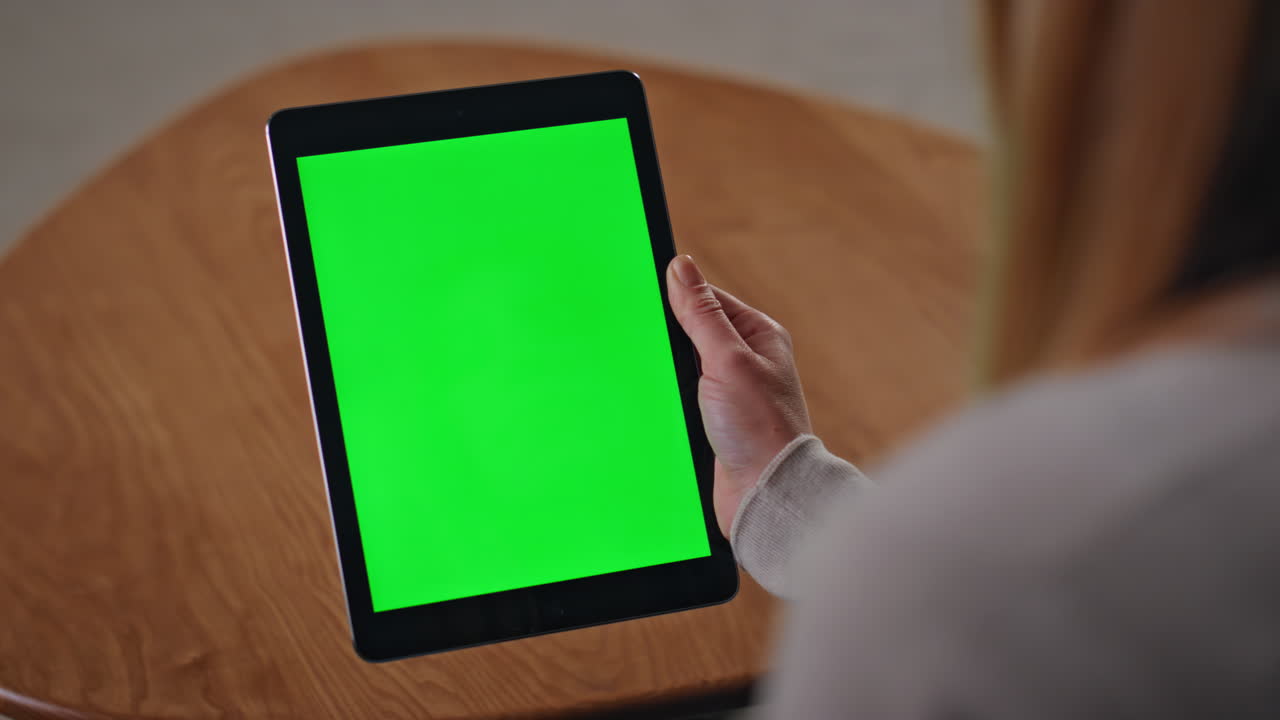 Web designer zooming mockup tablet working remotely at home desk close up.