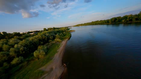 fpv aerial shot over the shore of the beach of vistula river, warsaw, poland