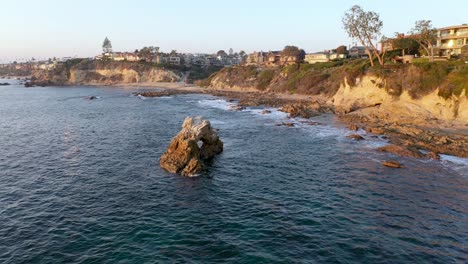 rotating around million dollar beach front luxury homes and a private beach in beautiful laguna beach california tide pools at sunset in stunning 4k resolution