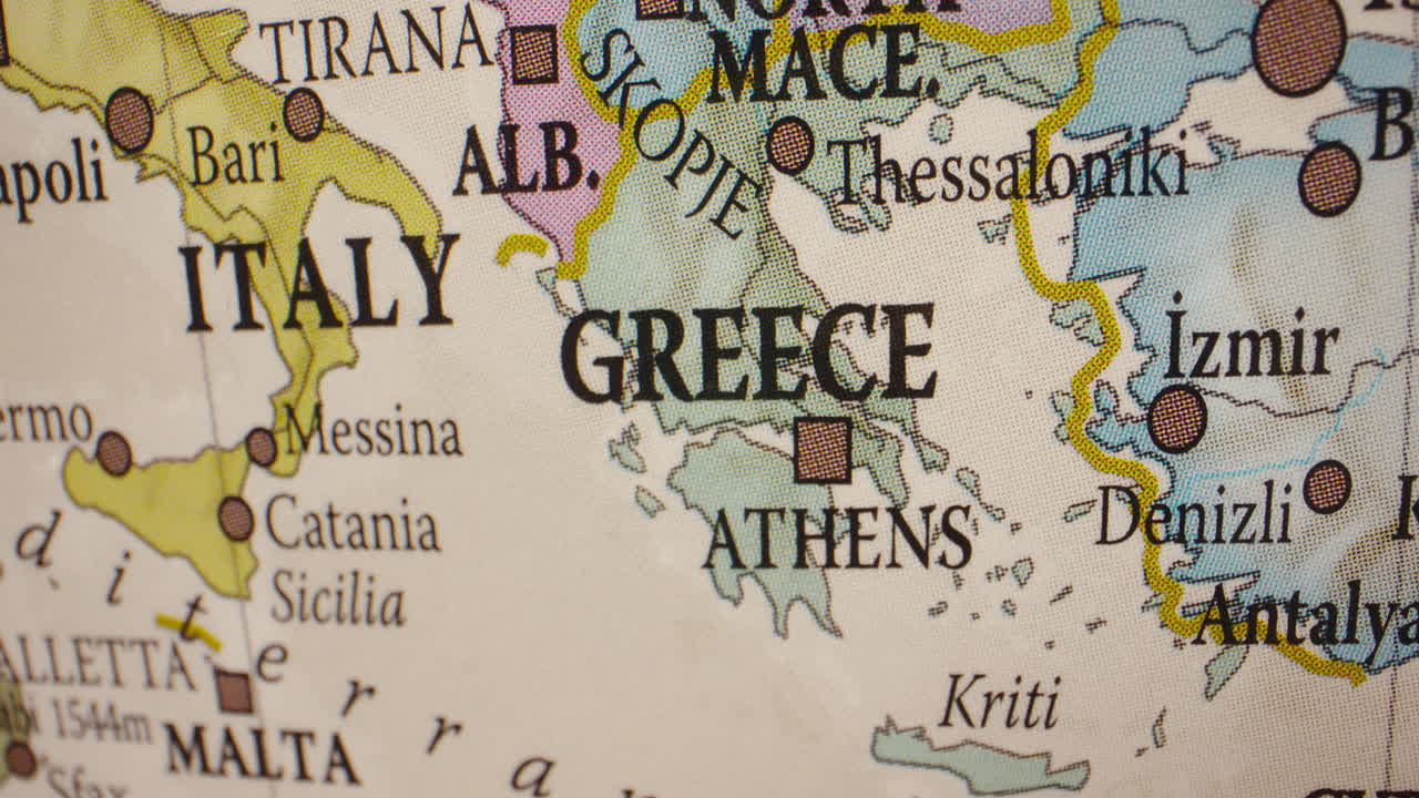 Close-up of a map or globe showing Greece, Italy, and surrounding Mediterranean countries