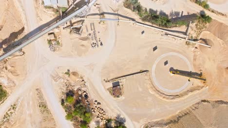 Bird's-Eye-View-Of-Limestone-Quarry-With-Machinery-And-Mining-Equipment---drone-shot