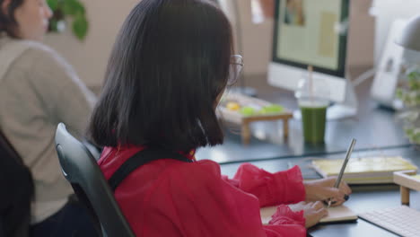 young asian business woman student using computer working brainstorming marketing project writing study notes browsing online research in modern office