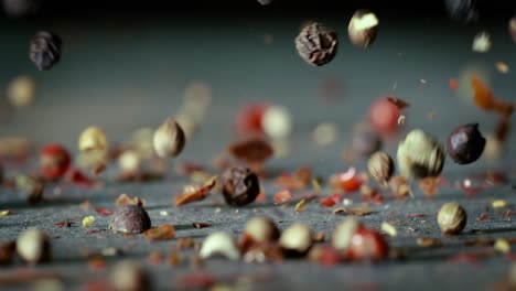 mixed peppercorns in a super slow motion. dry mix peppercorns close up.