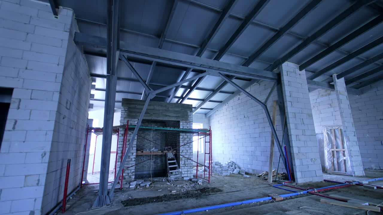 Commercial site renovation updates. Workers are on-site at a commercial building renovation, surrounded by steel frameworks and construction materials