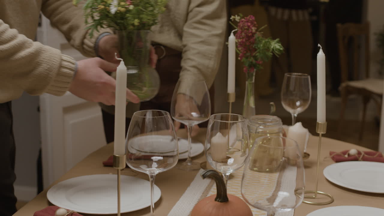 Festive table setting with candles and pumpkin