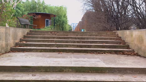 Peeking-behind-stairs-in-public-park-in-Paris-France