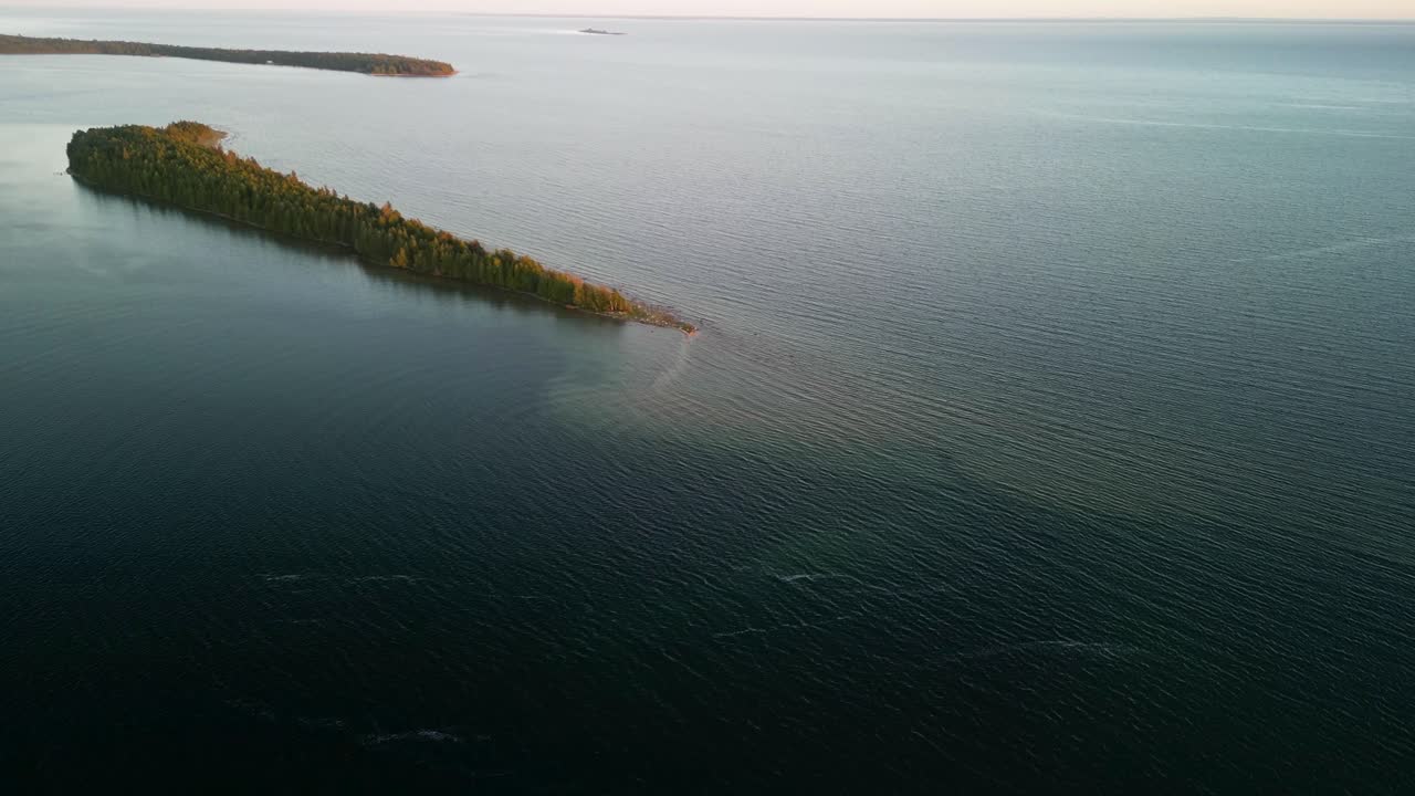 Aerial reveal of birch island at golden hour, les cheneaux islands, michigan