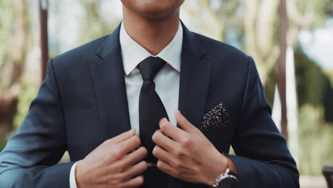 Hands,-wedding-and-tie-with-a-groom-getting