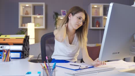 business woman working in home office has a sore neck.