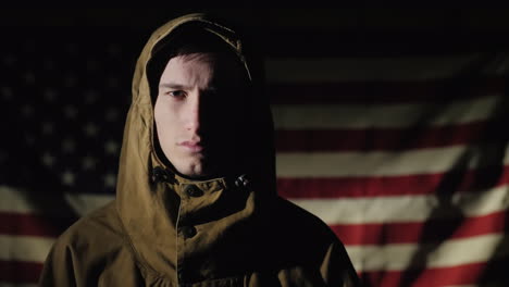 Portrait-Of-A-Young-Male-Soldier-On-The-Background-Of-The-American-Flag