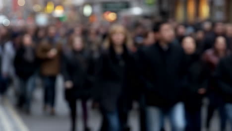 blurred crowd of people walking on a city street