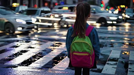 girl crossing a wet city street at night