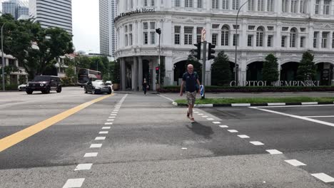 people crossing street at city intersection.