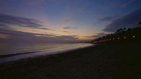 empty beach near the coast of marbella after sundown